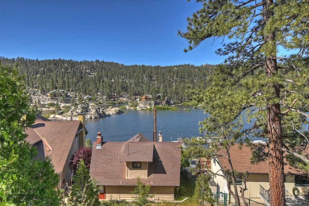 Scenic Boulder Bay lake view with mountain landscape, pine trees, and cabins near the shoreline.