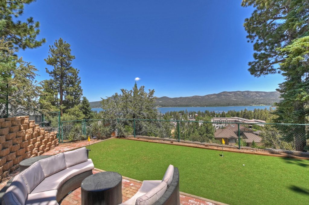 Backyard seating area with putting green overlooking Big Bear Lake and surrounding mountains.