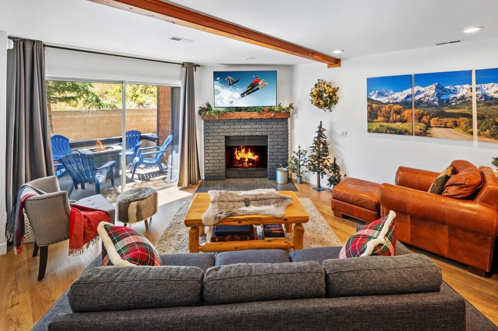 Ski In Ski Out at Bear Mountain living room with fireplace, mountain artwork, and outdoor seating