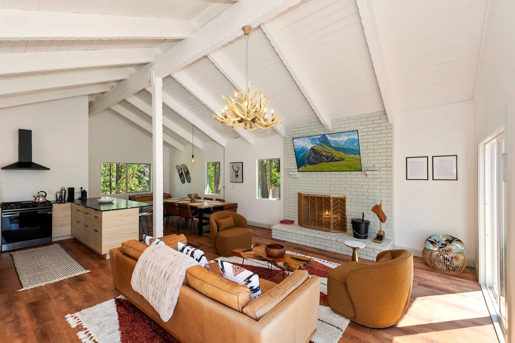 Vista Chalet interior with modern kitchen, cozy seating, fireplace, and open living space