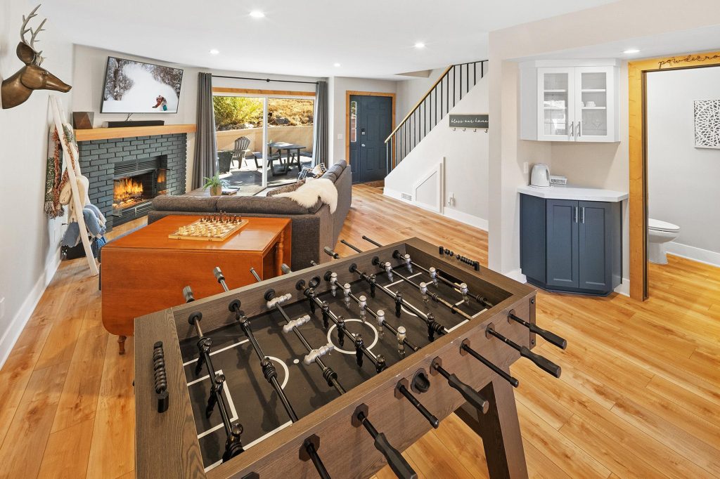 Slopeside at Bear Mountain game room with foosball table, fireplace, seating area, and mountain-inspired decor