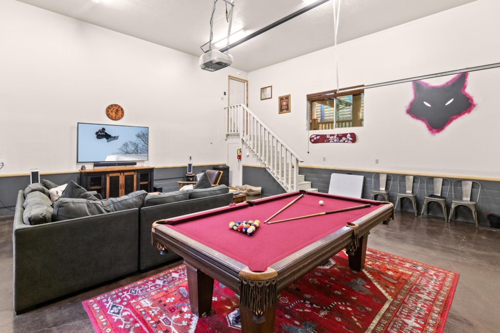Lone Wolf Lodge game room with pool table, comfortable seating, TV area, and entertainment space