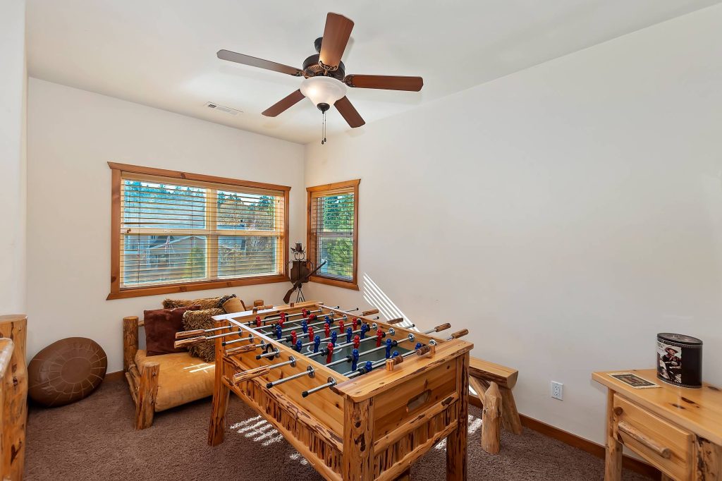 Longhorn Lodge game room featuring a foosball table, rustic seating, wooden decor, and a cozy entertainment space