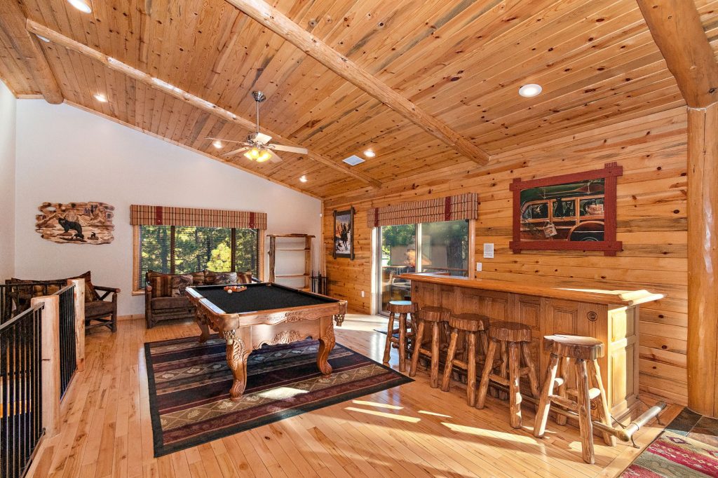 Stony Creek Lodge game room with a pool table, rustic bar, wooden ceiling, and comfortable seating