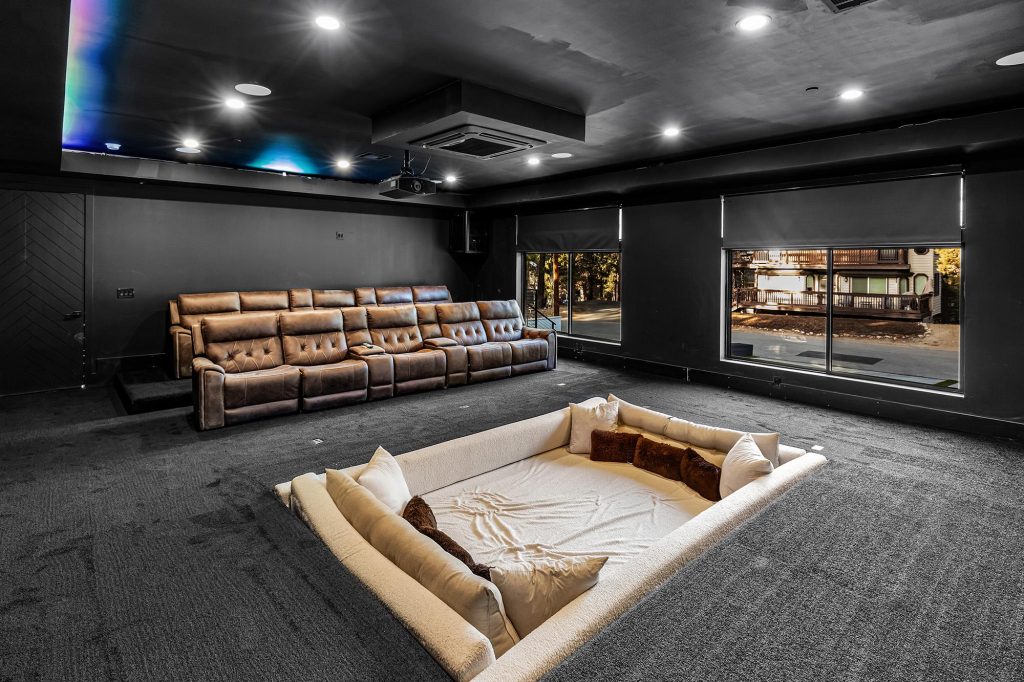 Luxury home theater with leather reclining seats, projector, and comfortable lounge seating at The Getaway Club