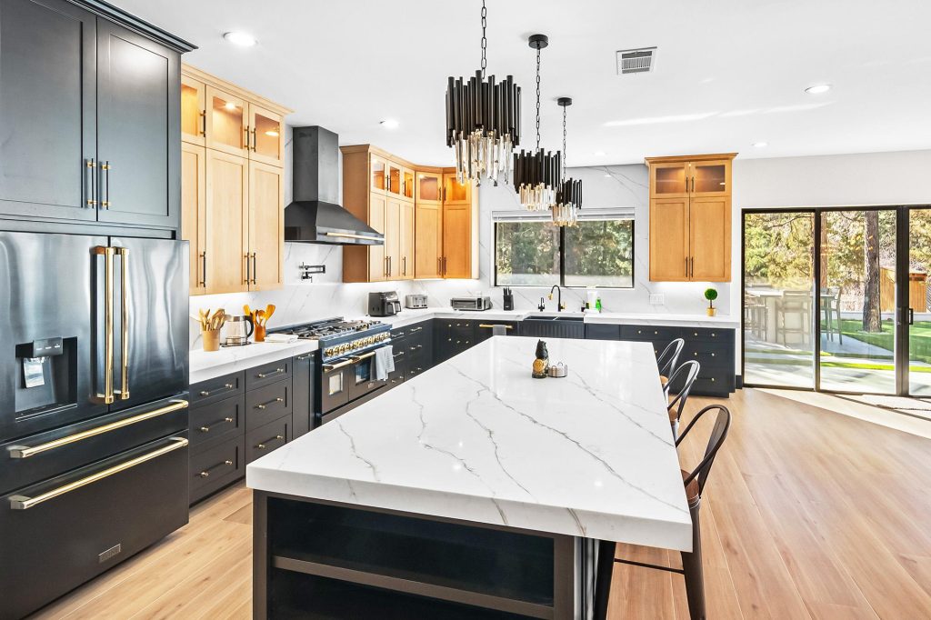 Modern kitchen interior at The Getaway Club featuring a large island, stylish cabinets, premium appliances, and bright open living space