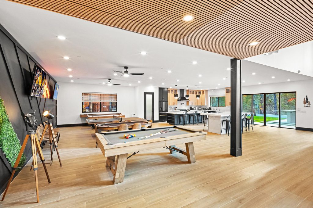 A game room at The Gateway Club in Big Bear featuring a pool table and a bar area for socializing and entertainment.