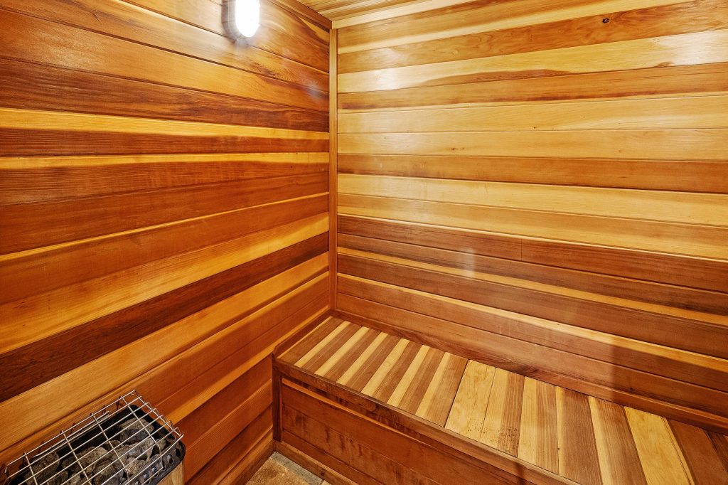 Wooden sauna interior at Talmadge Lodge featuring cedar walls, built-in benches, and a relaxing wellness space in Big Bear Lake, CA