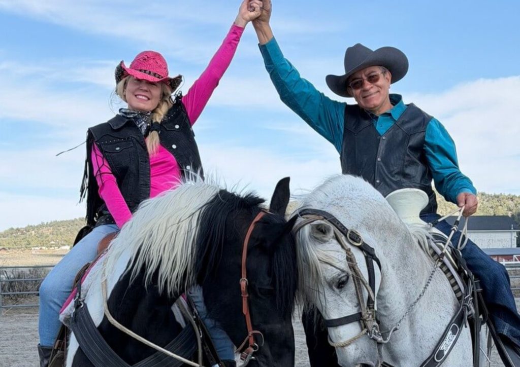 Two horseback riders celebrating together at Starlight Equestrian Ranch in Big Bear City.