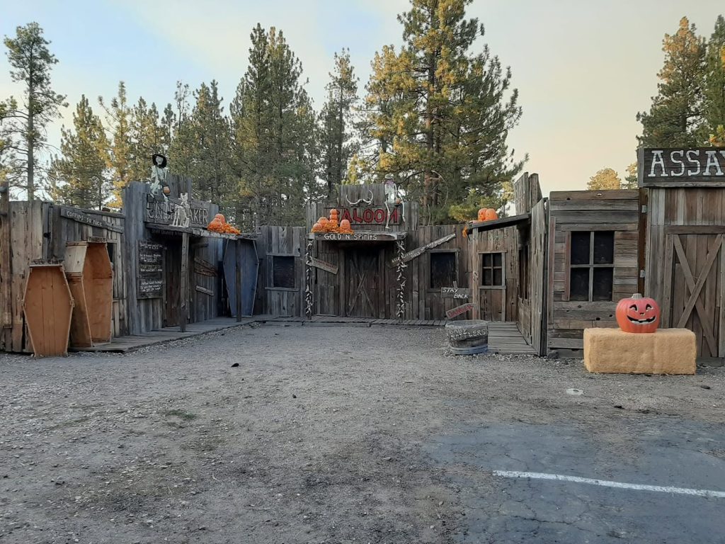 Halloween-themed mining attraction area decorated with pumpkins and spooky western displays