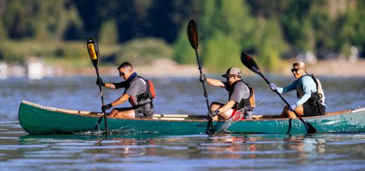 Three people canoeing on a lake at Big Bear.