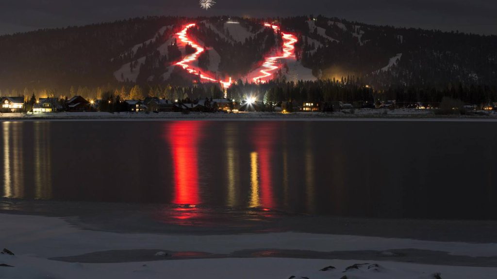 Skiers prepare for Big Bear’s New Year’s Eve Torchlight Parade at night