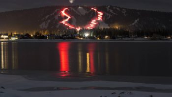 Skiers prepare for Big Bear’s New Year’s Eve Torchlight Parade at night