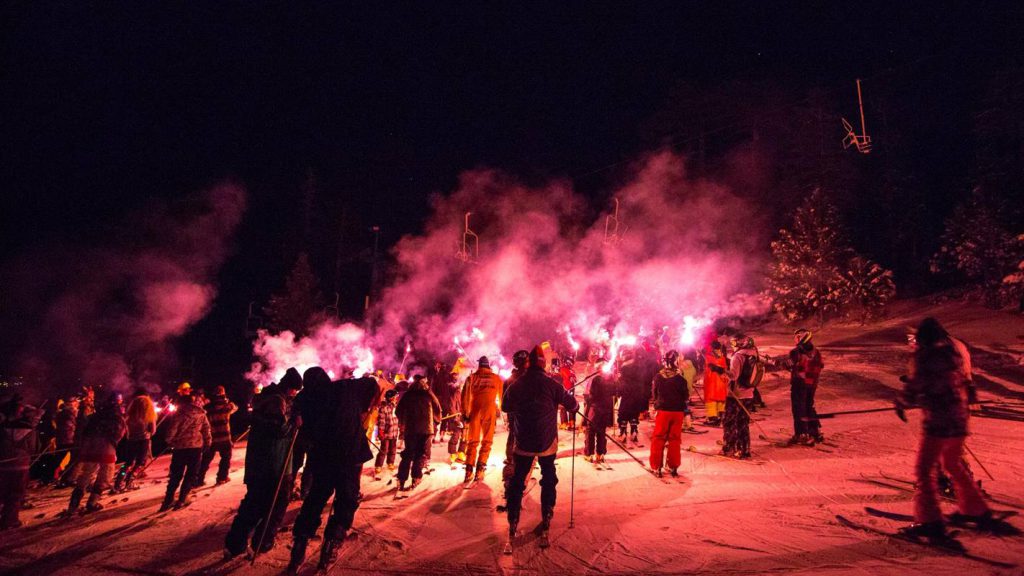 Skiers prepare for Big Bear’s New Year’s Eve Torchlight Parade at night