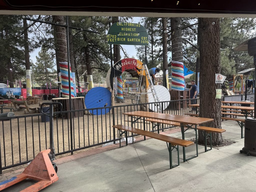 Scenic park in Big Bear, California, with picnic tables, festive decor, and a family-friendly Oktoberfest atmosphere.