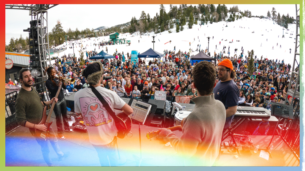 Crowd enjoying an outdoor AJR concert with colorful gradient overlay