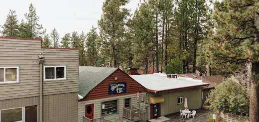 Mystic Rose Studios in Big Bear, featuring a building, parking lot, and surrounding trees.