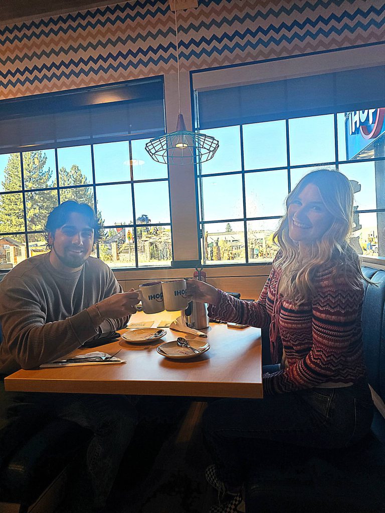 Couple enjoying coffee and breakfast inside IHOP and Applebee’s in Big Bear Lake