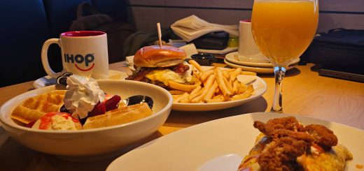 Table with breakfast omelet, waffles, burger, and orange mimosa at IHOP and Applebee’s Big Bear Lake