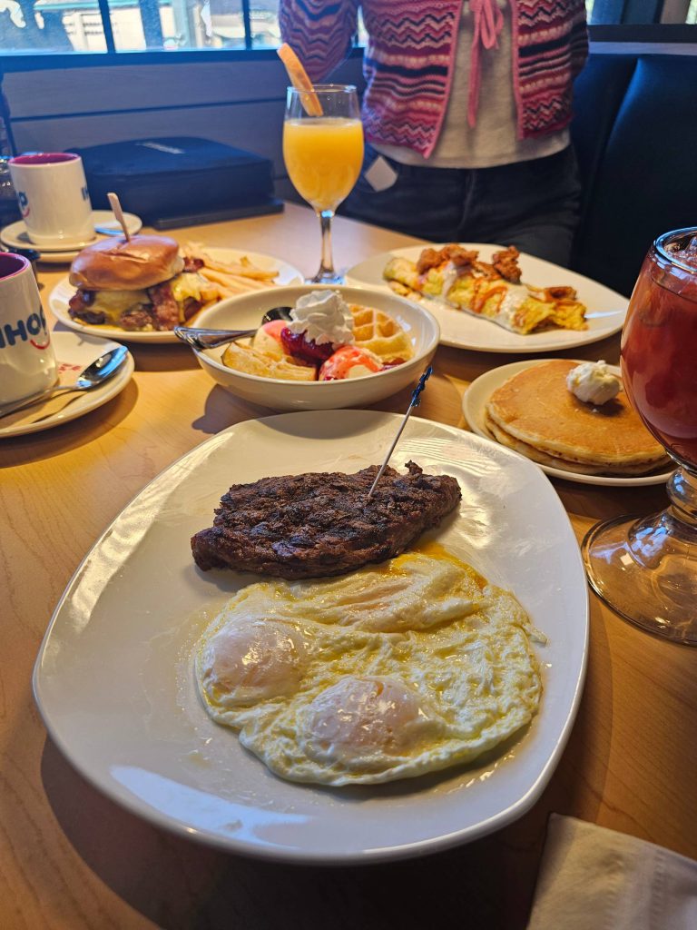 Steak and eggs breakfast served with waffles, omelet, and orange mimosa at IHOP and Applebee’s Big Bear Lake