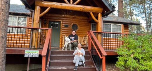 Guests with Ghost and Sandy on the front steps of The Crazy Bear cabin in Big Bear