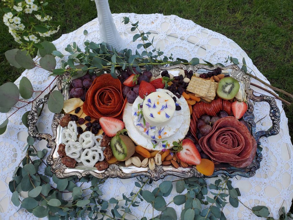 A beautifully arranged tray of fruit and nuts on a table, part of an elegant charcuterie and cheese platter in Big Bear.