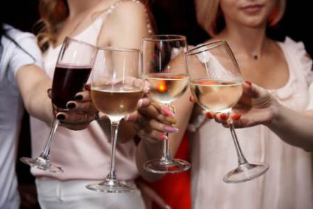 Group of friends toasting wine glasses at social gathering during Big Bear event