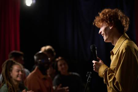Stand-up comedy performance with entertainer on stage engaging audience at Big Bear event