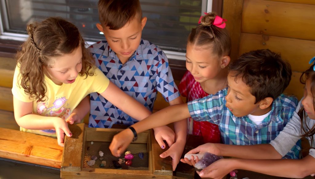 Children enjoying a hands-on gem mining activity at Gold Rush Mining Co