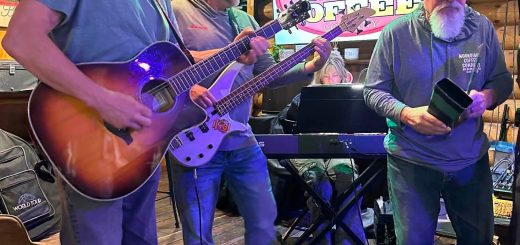 Live music performance at Moonridge Coffee Company with musicians playing guitar and bass