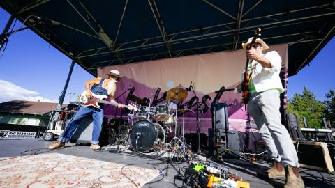 A band performing live music on an outdoor stage at the Big Bear LakeFest event.