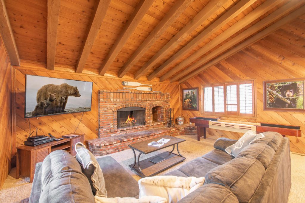 Cozy wooden living room with fireplace and TV in Big Bear.