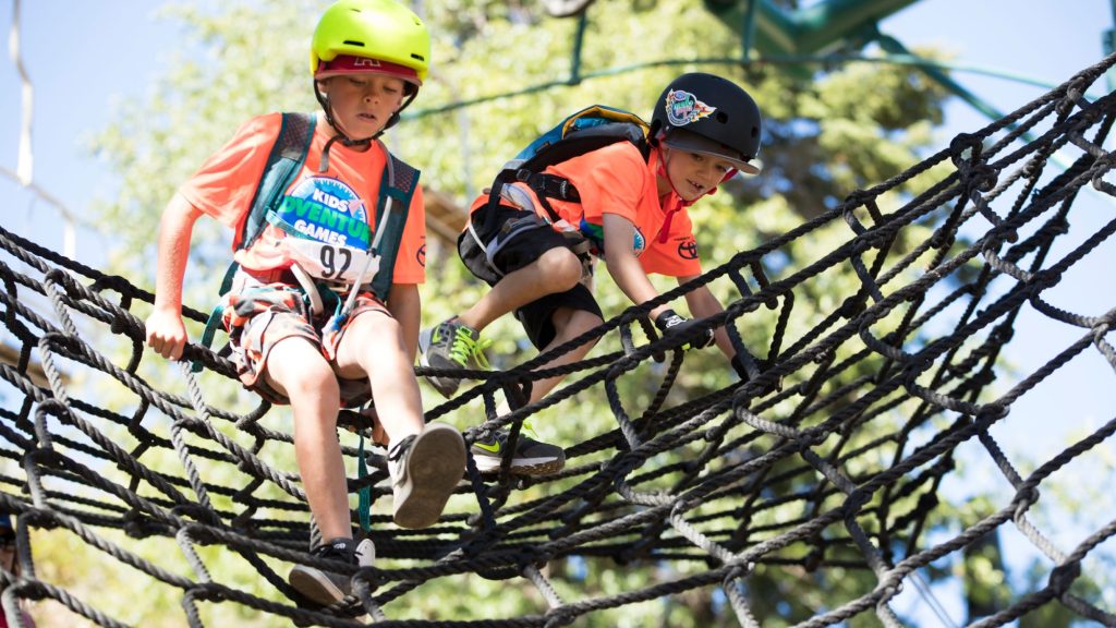 kids climbing rope obstacle during Kids Adventure Games Big Bear outdoor challenge