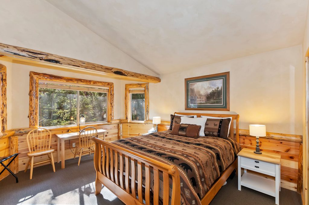 Bear Butte Lodge bedroom on log bed frame with window