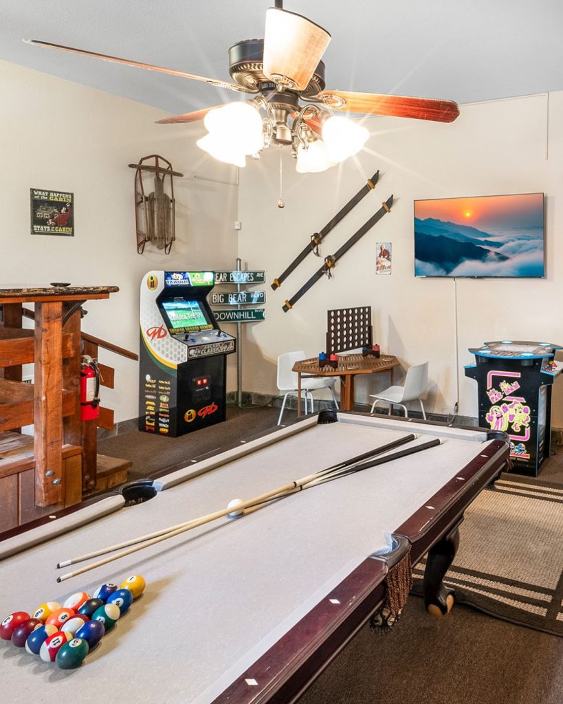 Bear Escapes game room featuring a pool table, arcade games, and family entertainment area.