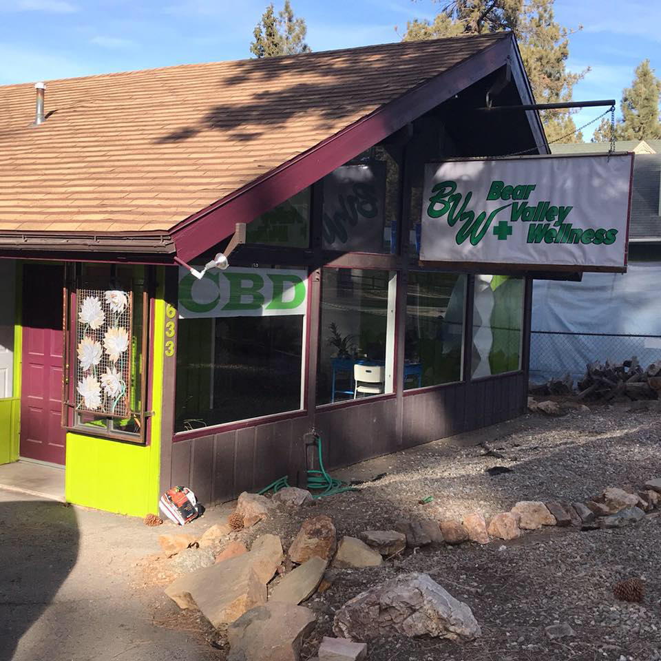 Exterior of Bear Valley Wellness Center showing signage, front windows, and entrance with green and brown facade.