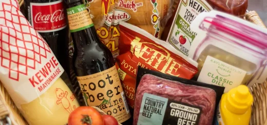 A basket overflowing with various food and drink items, showcasing fresh and packaged goods in Big Bear.