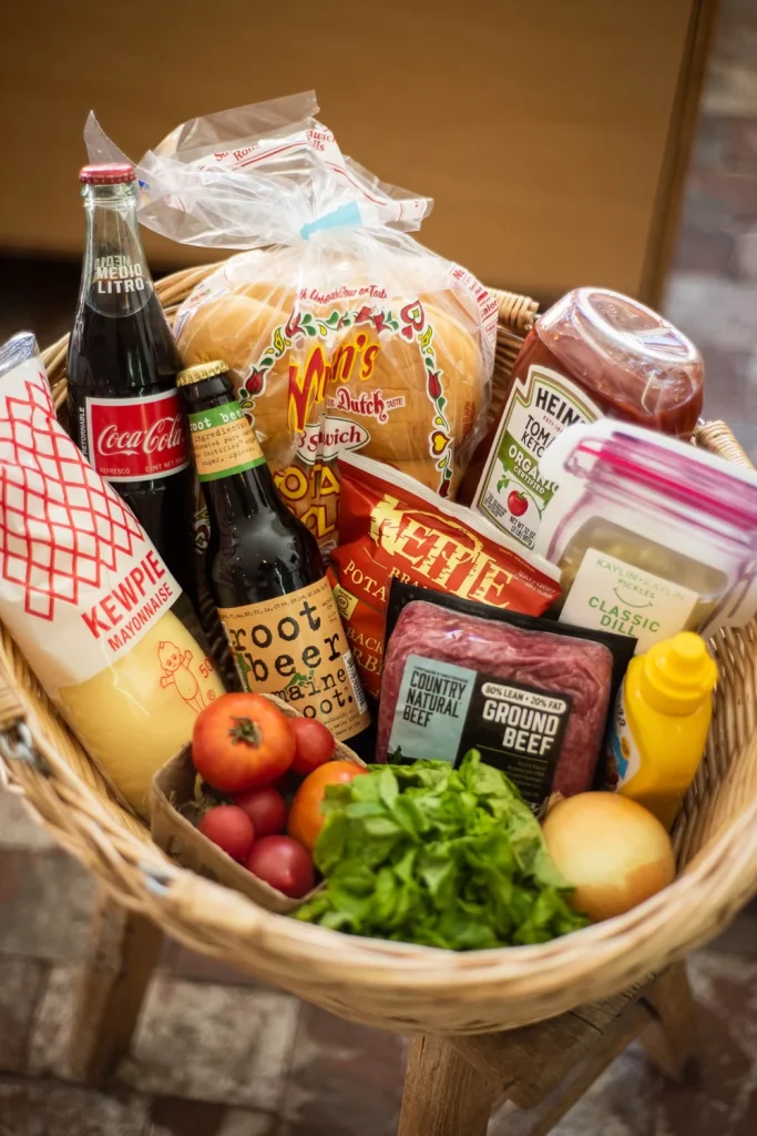 A basket overflowing with various food and drink items, showcasing fresh and packaged goods in Big Bear.