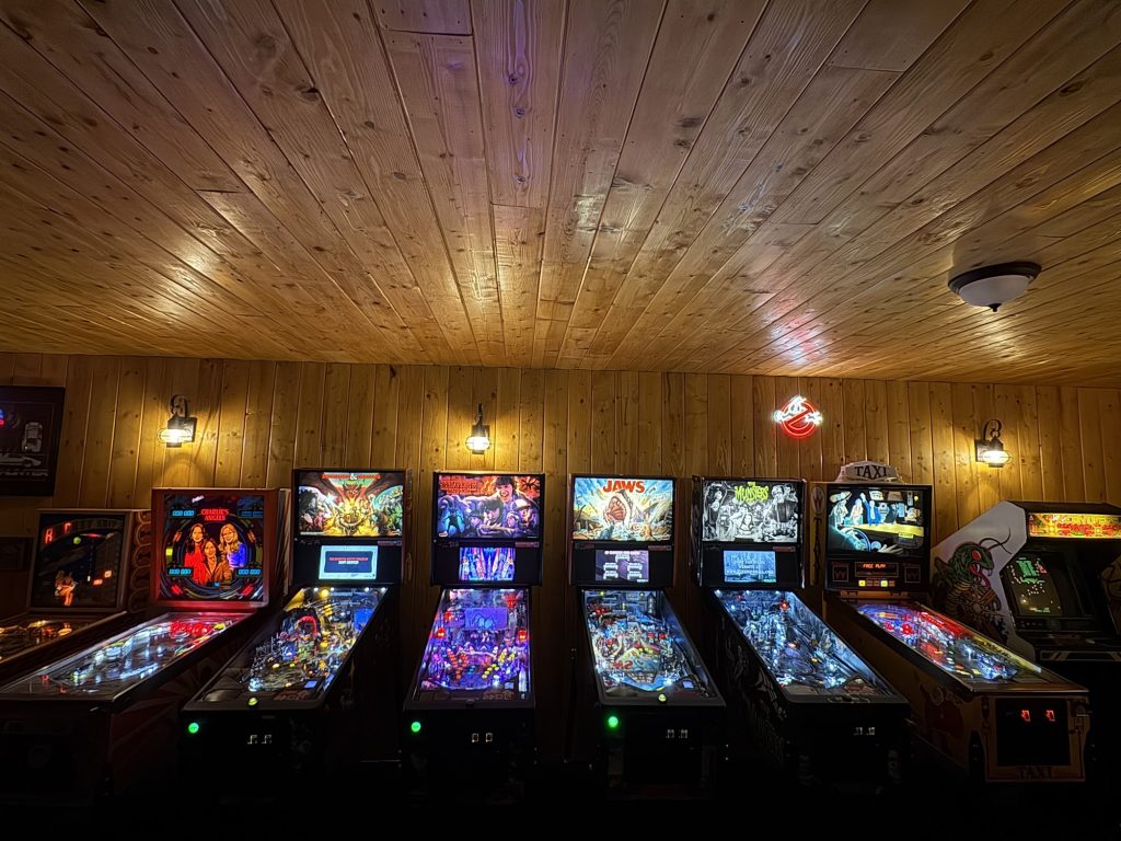 Retro arcade room featuring classic pinball machines and vintage games in Big Bear.