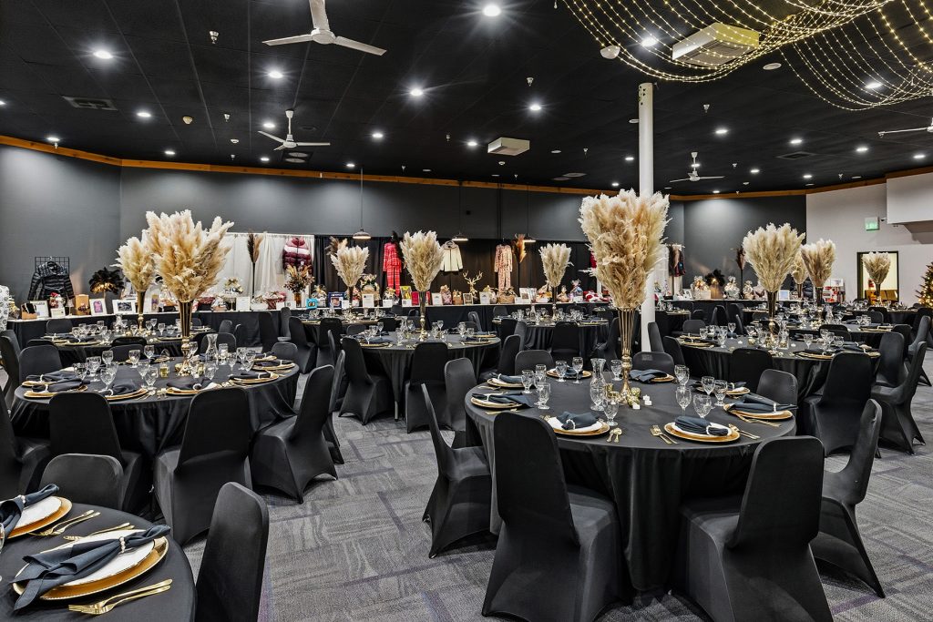 Spacious banquet room with decorated tables and modern lighting setup