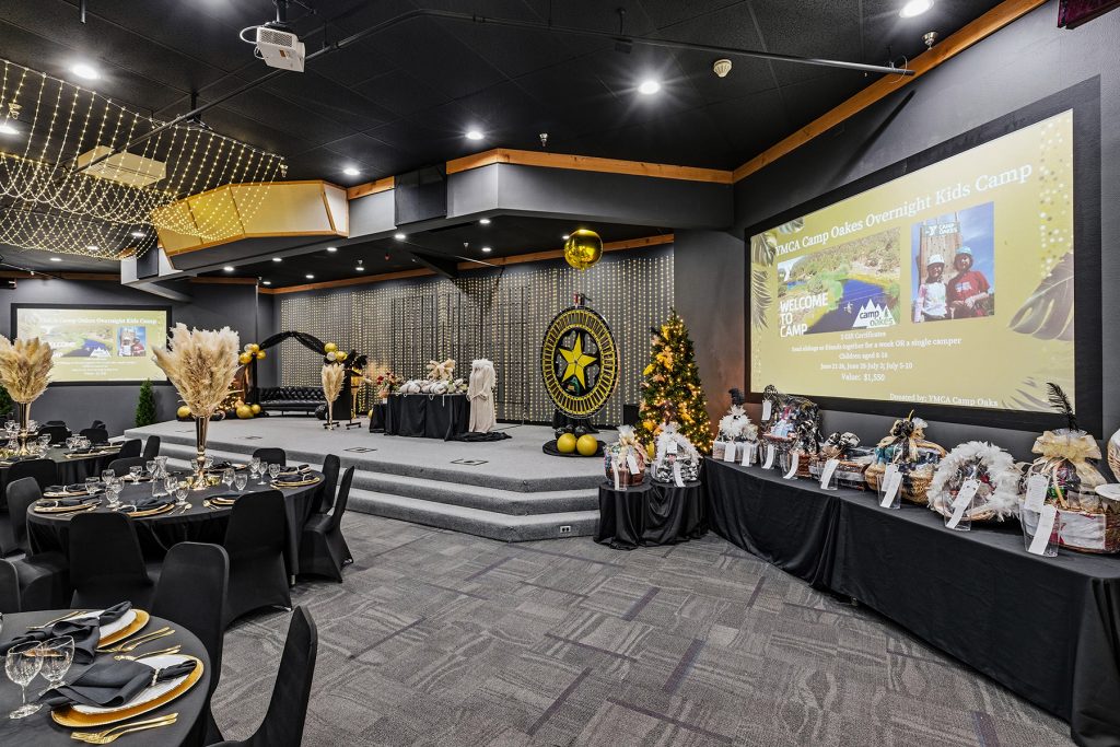 Event stage with presentation screen and banquet seating arrangement