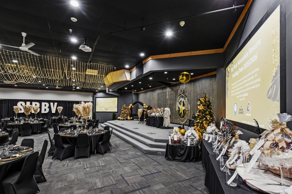 Holiday-themed banquet setup with Christmas tree and decorated stage