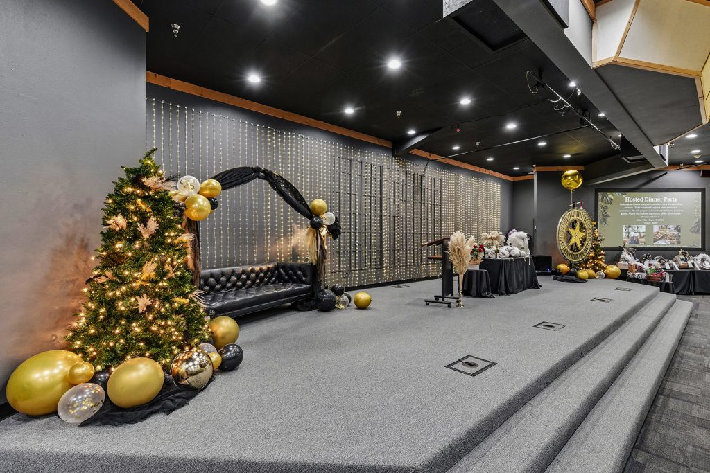 Large banquet hall decorated for formal event with table arrangements