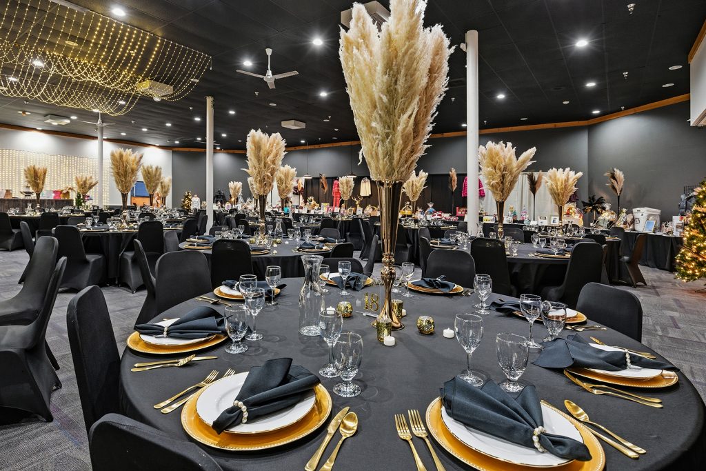 Banquet hall interior with illuminated backdrop and event seating