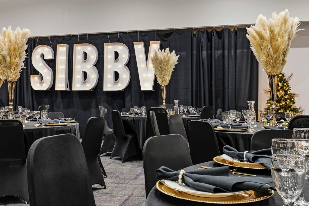 Banquet table setup with glassware and decorative centerpiece