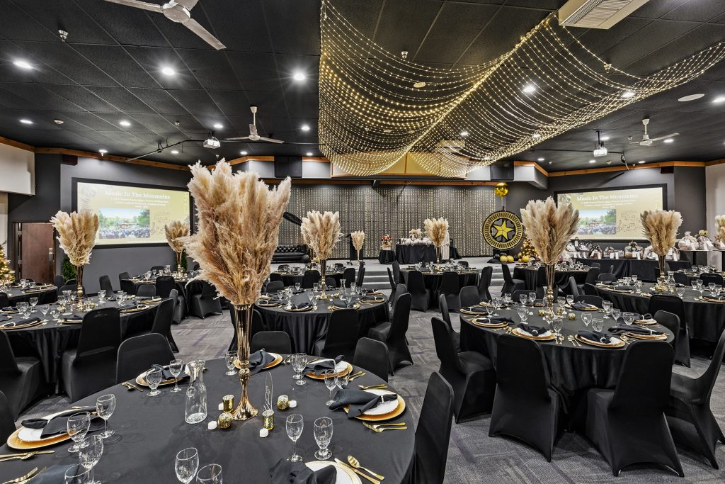 Banquet hall overview with neatly arranged tables and lighting