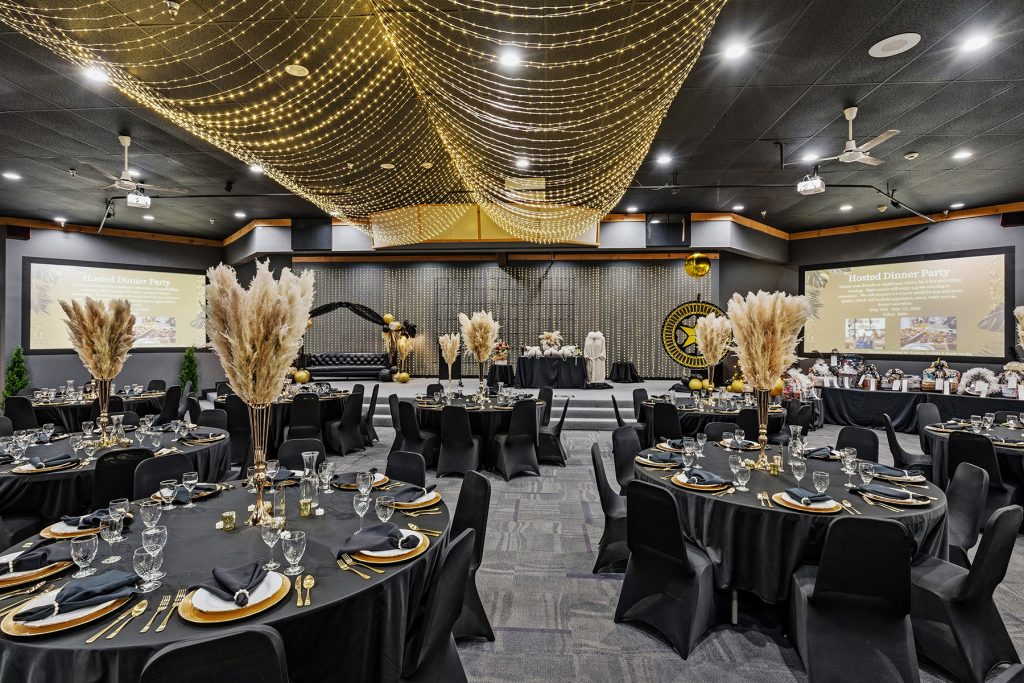 Elegant event hall with warm lighting and table arrangements