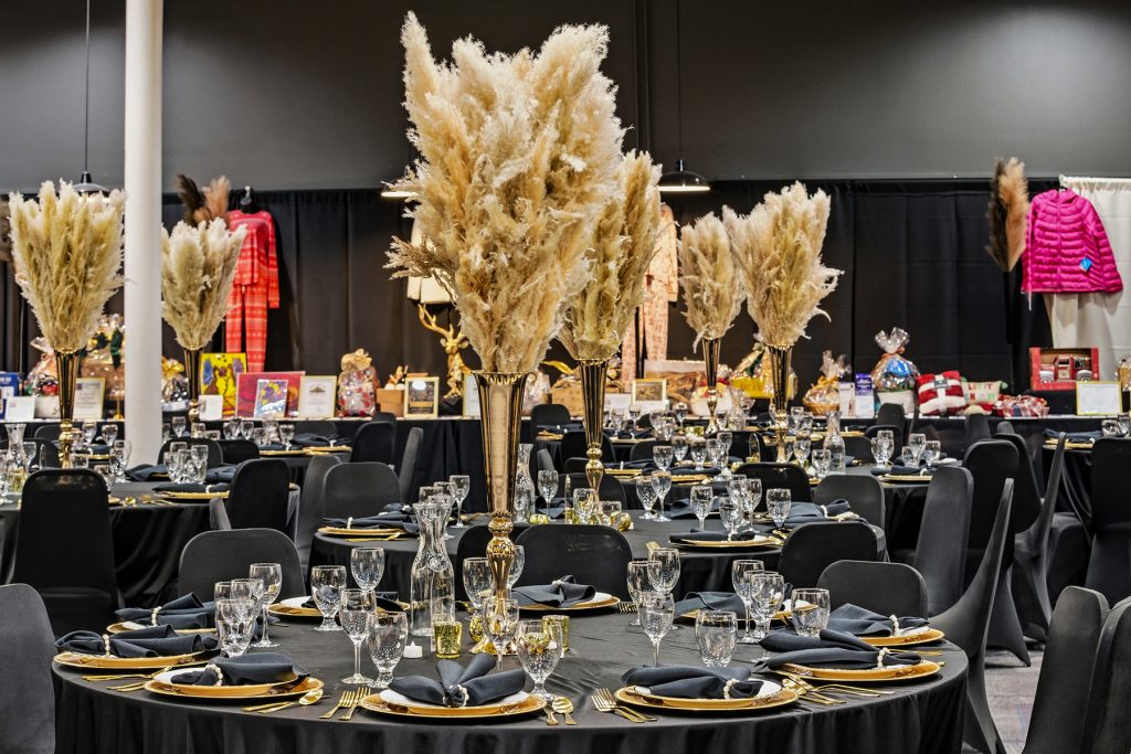 Event venue with luxury table settings and festive decorative displays