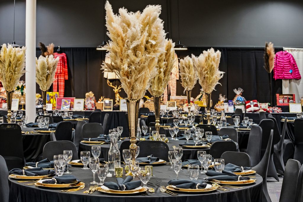 Banquet room with illuminated backdrop and raffle display setup