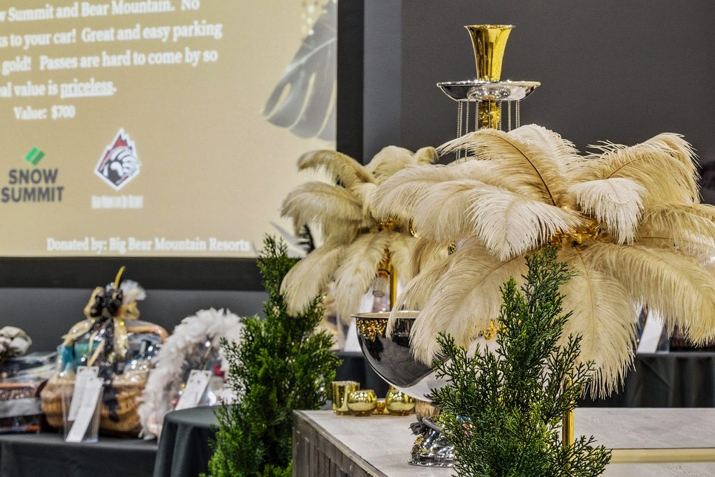 Decorative event setup with large illuminated letters and pampas grass centerpieces